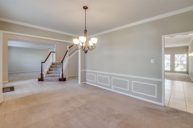 carpeted empty room with crown molding and a chandelier