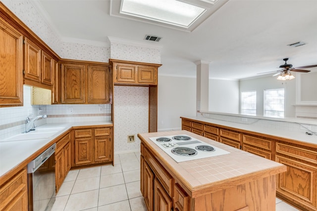 kitchen with a kitchen island, dishwasher, sink, crown molding, and white electric stovetop