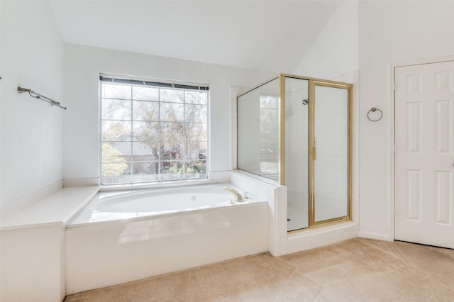 bathroom featuring shower with separate bathtub and vaulted ceiling