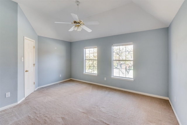 carpeted empty room with vaulted ceiling and ceiling fan