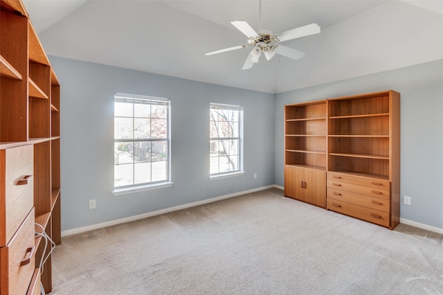 unfurnished bedroom with ceiling fan, light colored carpet, and lofted ceiling