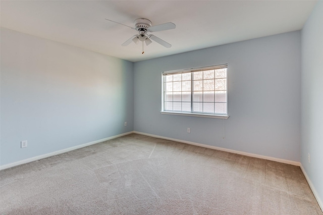 unfurnished room with light colored carpet and ceiling fan