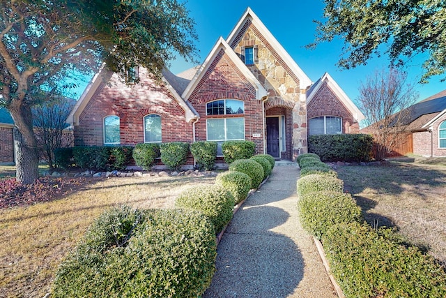 tudor home featuring a front yard