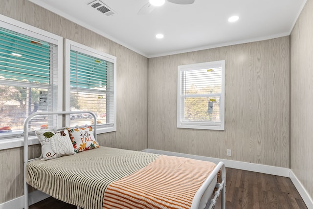 bedroom with dark hardwood / wood-style floors, multiple windows, crown molding, and ceiling fan