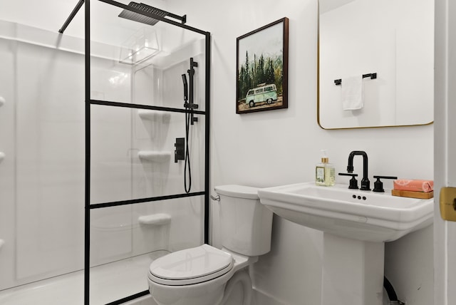 bathroom featuring sink, toilet, and walk in shower