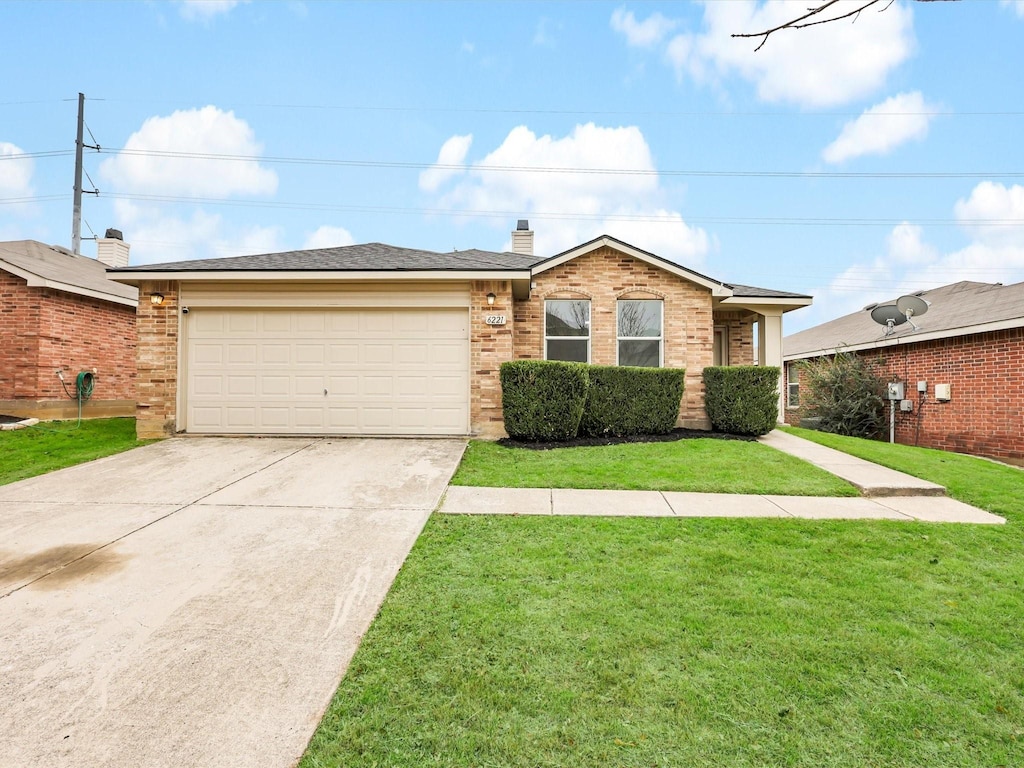 ranch-style house with a garage and a front lawn