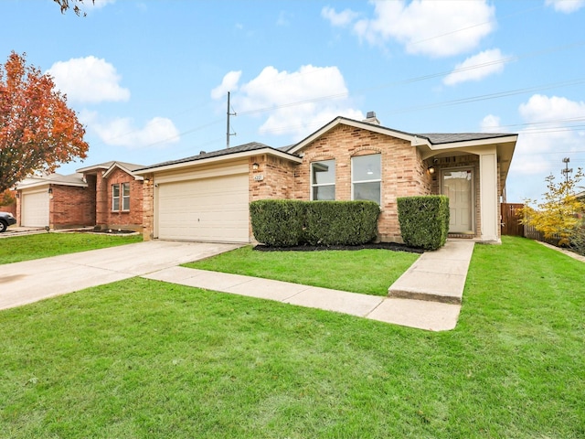 single story home featuring a garage and a front lawn