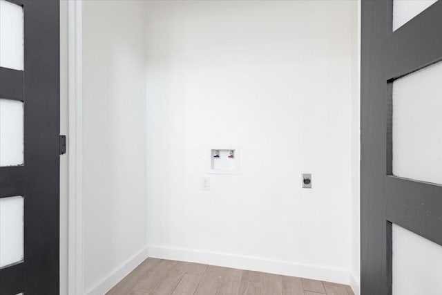 laundry room with electric dryer hookup, light wood-type flooring, and hookup for a washing machine