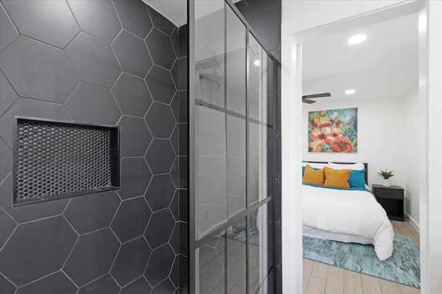 bathroom featuring a shower, ceiling fan, and wood-type flooring