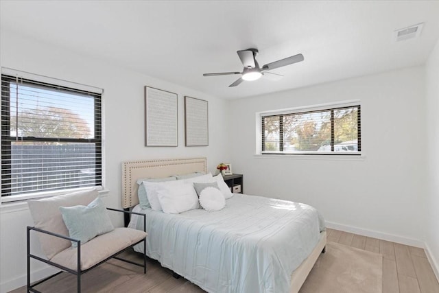 bedroom with ceiling fan and light wood-type flooring