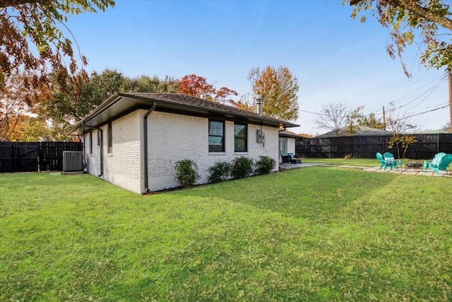 back of house featuring a lawn and cooling unit