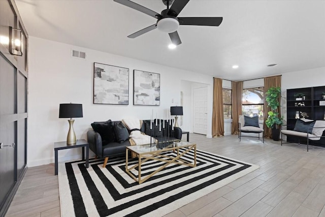 living room featuring light hardwood / wood-style floors and ceiling fan