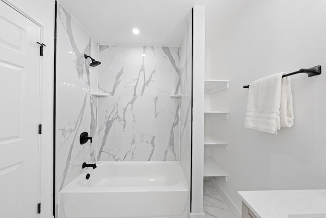 bathroom with vanity and tiled shower / bath combo