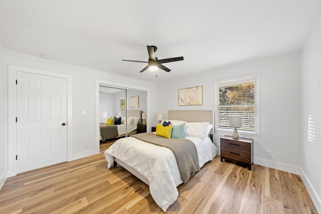 bedroom with ceiling fan, light hardwood / wood-style floors, and a closet