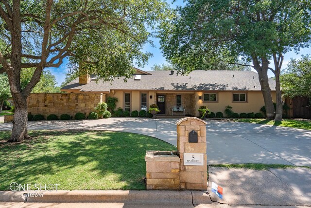 ranch-style house with a front lawn