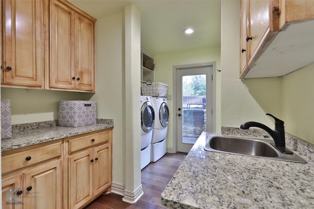 laundry area featuring washer and clothes dryer, dark wood-type flooring, and sink