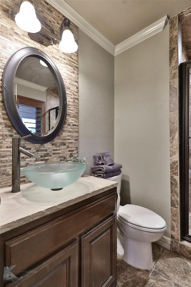 bathroom with vanity, ornamental molding, and toilet