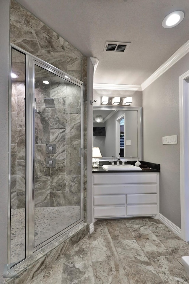 bathroom with vanity, an enclosed shower, and ornamental molding