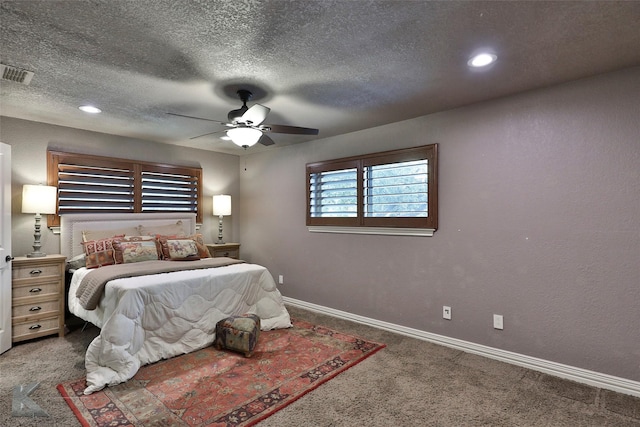 carpeted bedroom featuring ceiling fan and a textured ceiling