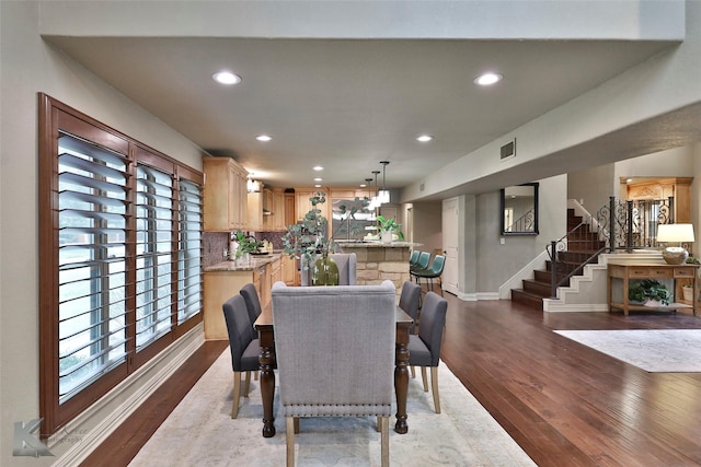 dining space featuring wood-type flooring