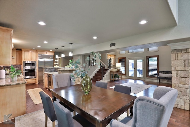 dining space featuring french doors and dark wood-type flooring