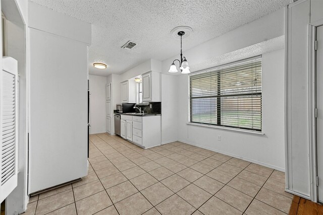 kitchen featuring light tile patterned flooring, white cabinetry, hanging light fixtures, and an inviting chandelier