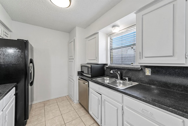 kitchen featuring white cabinets, sink, stainless steel appliances, and a textured ceiling