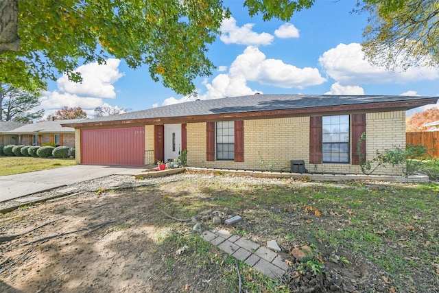 ranch-style house featuring a garage and a front lawn