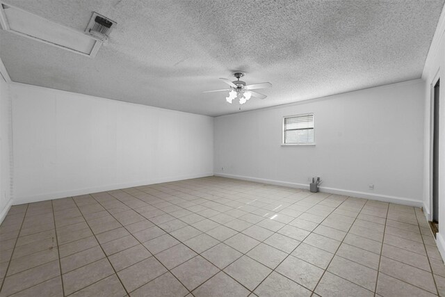 unfurnished room with a textured ceiling, ceiling fan, and light tile patterned flooring