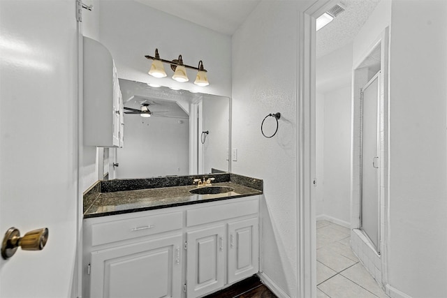 bathroom featuring vanity, tile patterned floors, ceiling fan, a textured ceiling, and an enclosed shower