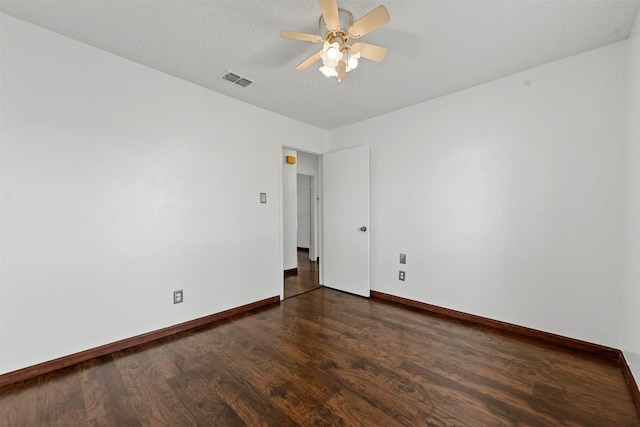 empty room featuring dark hardwood / wood-style flooring and ceiling fan