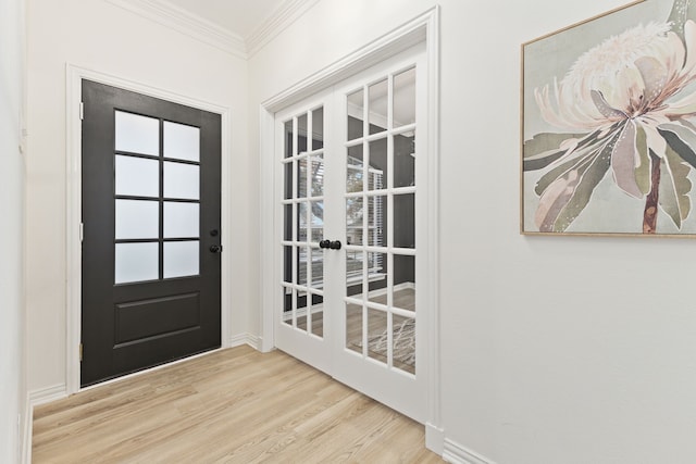 doorway to outside featuring light wood-type flooring and ornamental molding