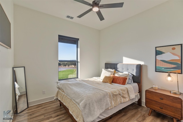 bedroom with ceiling fan and dark hardwood / wood-style floors