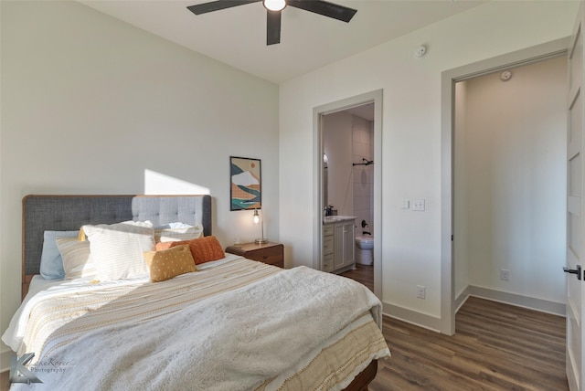 bedroom with ensuite bathroom, ceiling fan, and dark wood-type flooring