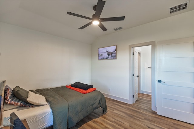 bedroom featuring ceiling fan, wood-type flooring, and lofted ceiling