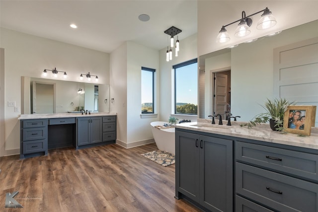 bathroom featuring vanity, a bath, and hardwood / wood-style flooring