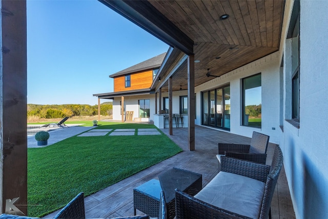 view of yard with an outdoor bar, ceiling fan, and a patio area