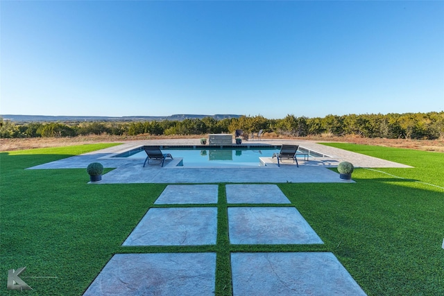 view of swimming pool with a yard and a patio area