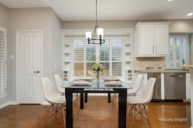 dining room featuring a wealth of natural light, a notable chandelier, baseboards, and dark wood-type flooring