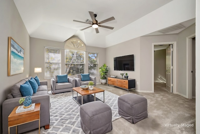 living room with lofted ceiling, visible vents, baseboards, a ceiling fan, and carpet