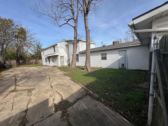 view of home's exterior with a lawn and a garage