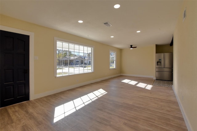 kitchen featuring light hardwood / wood-style flooring, stainless steel fridge, and ceiling fan