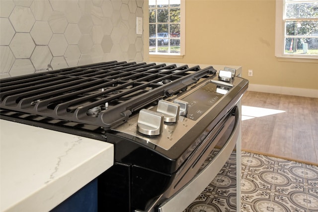 kitchen with lofted ceiling, wall chimney exhaust hood, dark hardwood / wood-style floors, white cabinets, and backsplash