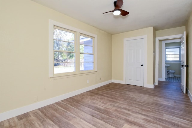 unfurnished bedroom featuring hardwood / wood-style flooring, ceiling fan, and a closet