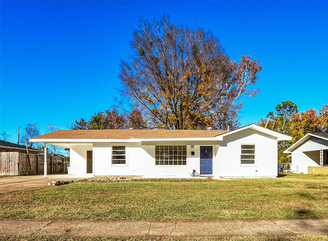 ranch-style home featuring a front yard and a carport