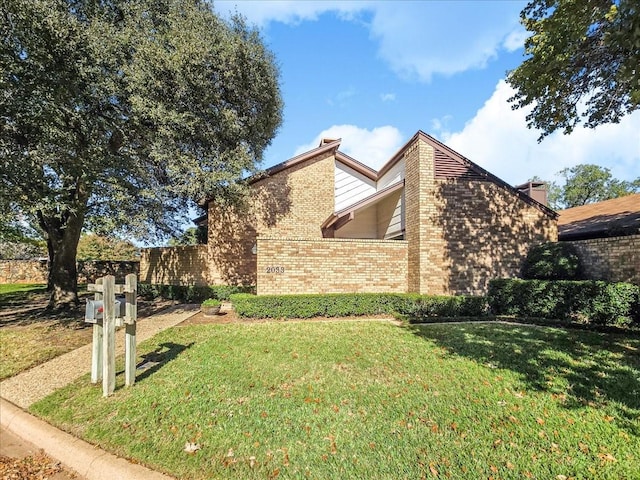 view of property exterior with a yard