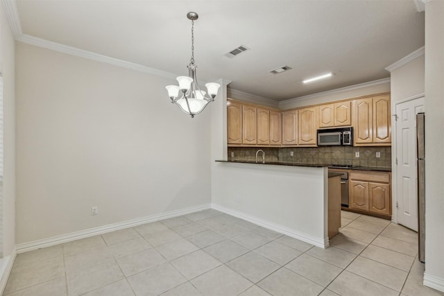 kitchen with decorative backsplash, light tile patterned floors, pendant lighting, and appliances with stainless steel finishes