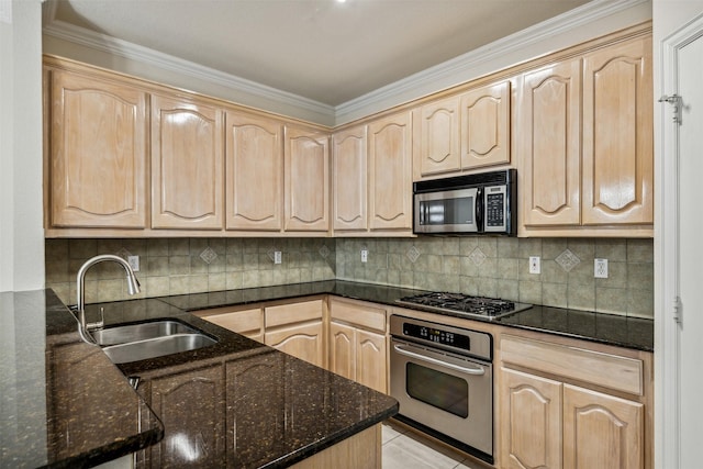 kitchen featuring dark stone counters, sink, decorative backsplash, light brown cabinetry, and appliances with stainless steel finishes