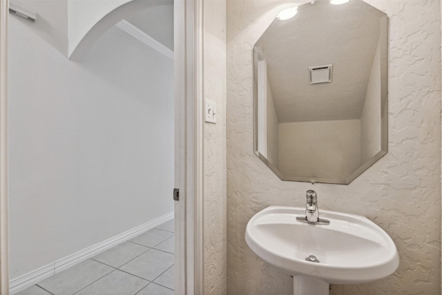 bathroom featuring tile patterned flooring, sink, and a textured ceiling