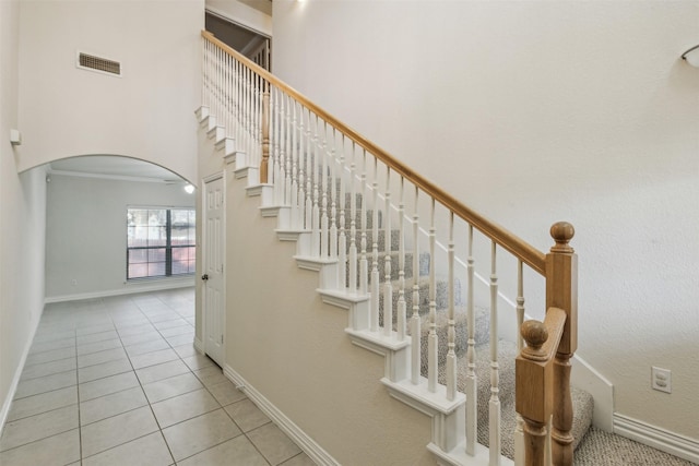 staircase featuring tile patterned floors